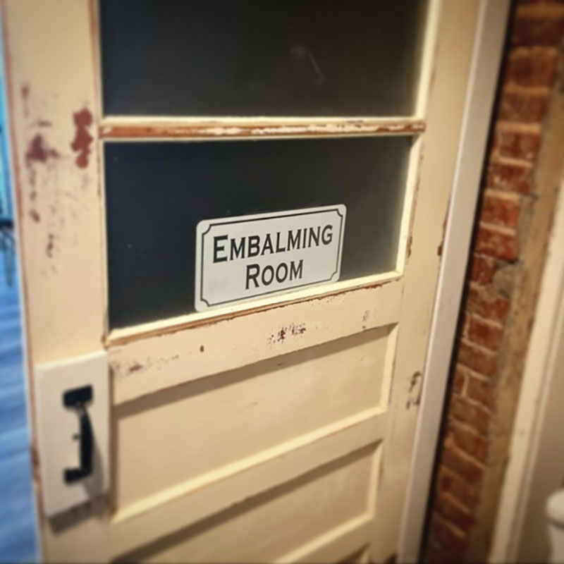 Alta recently discovered the large, spa-like bathroom was once the embalming room for the funeral home. A decorative “Embalming Room” sign hangs on the door leading to the restroom. Contributed Photo. 