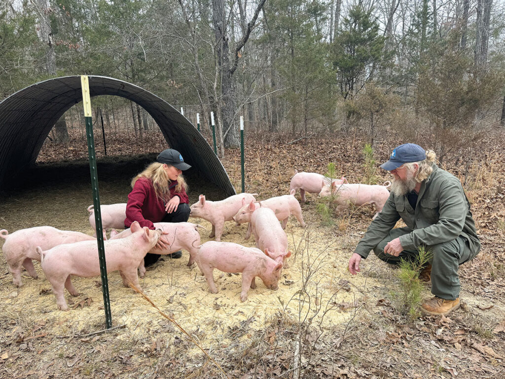 Eric and Sandy Jones offer pigs born and raised at Jones Hill Ranch. Photo by Sam MacPherson. 