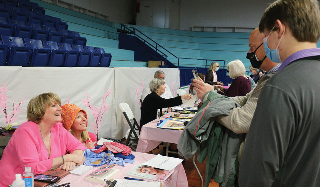 Alison Arngrim, known as Nellie Oleson on Little House on the Prairie, smiles with a fan as she gets a photo taken during the 2021 Cherry Blossom Festival in Marshfield. Arngrim is a fan favorite who often attends the festival.