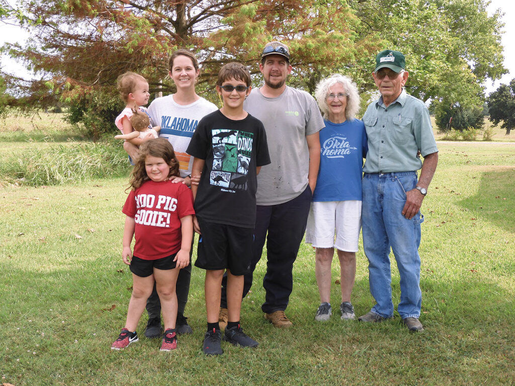 Clarence Woodward, pictured with his wife Pat, granddaughter Marcie Ketcher, her husband Colt, great-grandson Paxton, and great-granddaughters Kenedy and Timber, showed mechanical skills as a boy. Photo by Terry Ropp.