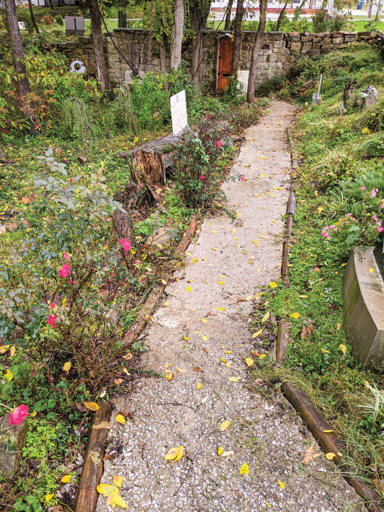 The Garden of God's Word has a paved pathway that visitors can find benches to rest on and inspirational bible quotes to read along the path. Photo by Eileen J. Manella.