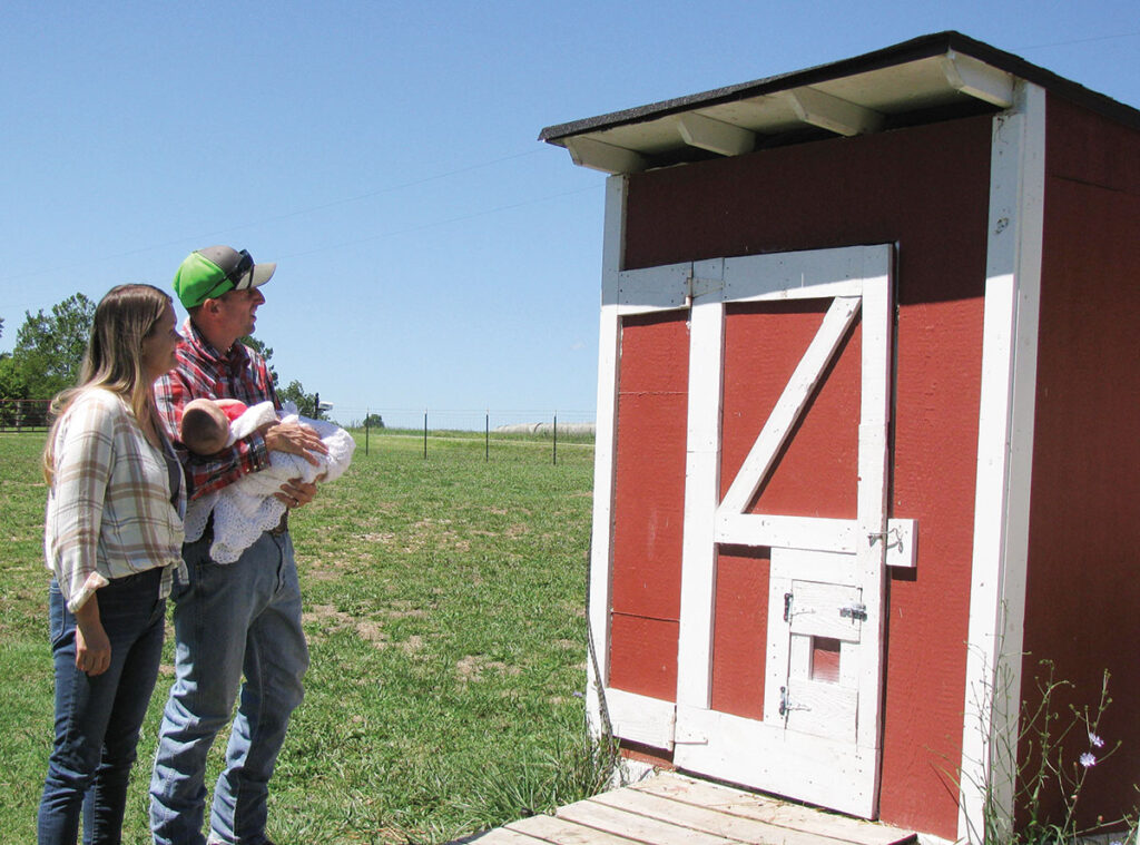 Last summer, Chris Crandall and his kids built a chicken coop. Chickens were easy for him and the kids while he waited for Sheena Crandall to retire from the air force. Photo by Brenda Brinkley. 