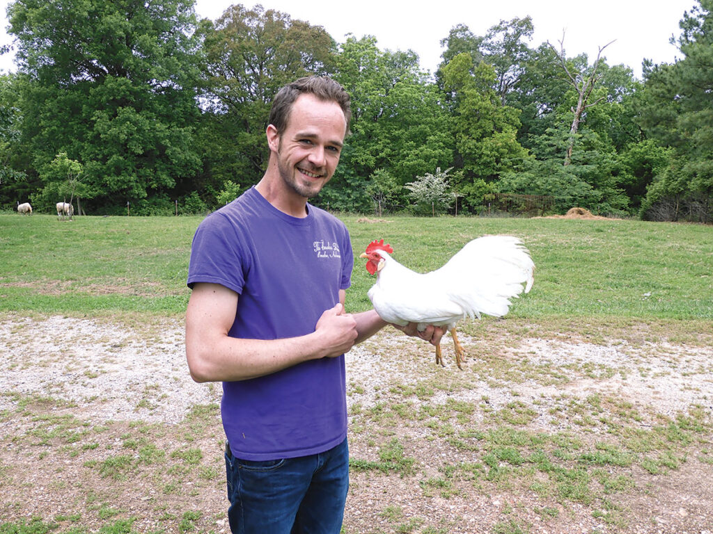 Brian Caraker with one of his chickens. He is a master breeder of the White Leghorn Bantam and half way to becoming a master with Rhode Island Red Bantams. Photo by Terry Ropp.