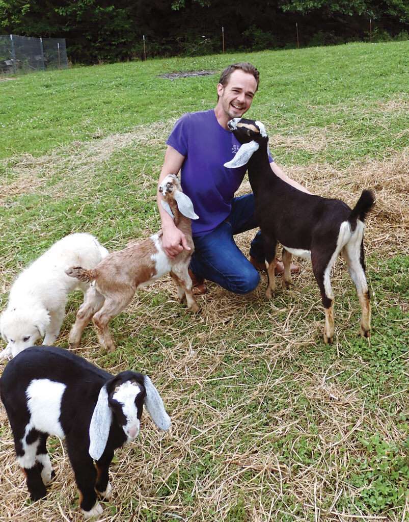 Brian Caraker with his goats at his farm in Omaha, Arkansas. Photo by Terry Ropp. 