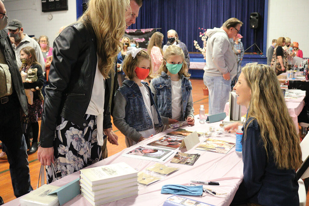 Fans talk with Wendi Lou Lee during the celebrity autograph show at the 2021 Cherry Blossom Festival. Lee portrayed Baby Grace Ingalls on “Little House of the Prairie.” 