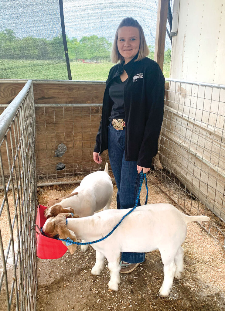 Callie Sweet with her goats. She is a member of the Diamond FFA chapter. Photo by Rachel Harper.