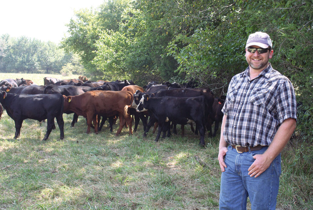 Dr. John Murphy with his cattle at his farm in Bolivar, Missouri. He is the associate biology professor at Southwest Baptist University in Bolivar, Missouri. Photo by Julie Turner-Crawford.