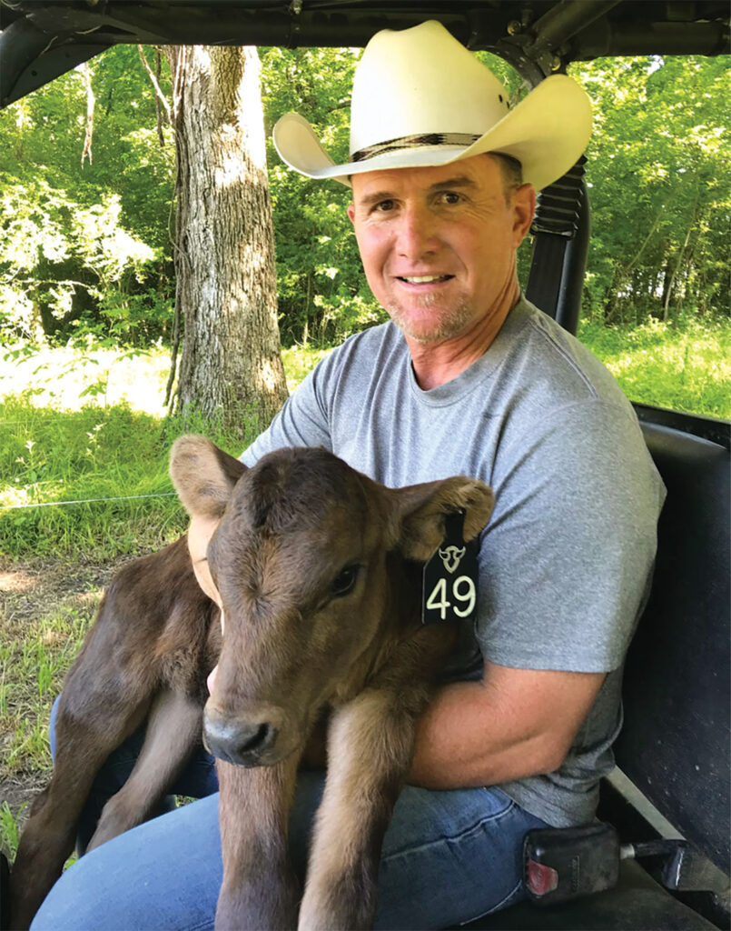William Rucker holding a calf. Submitted Photo.