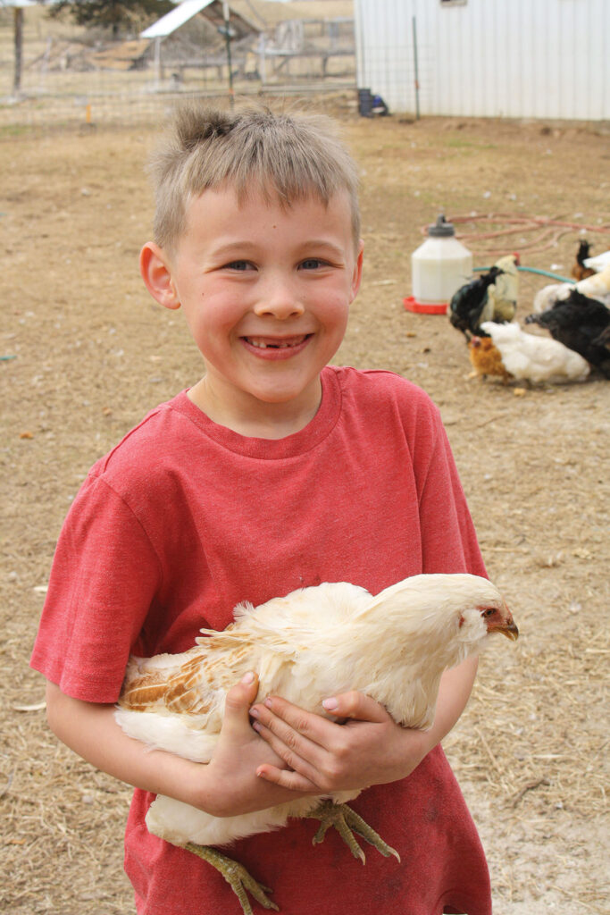 Thomas Gehris of Fair Grove, Missouri holding a chicken. Submitted Photo. 
