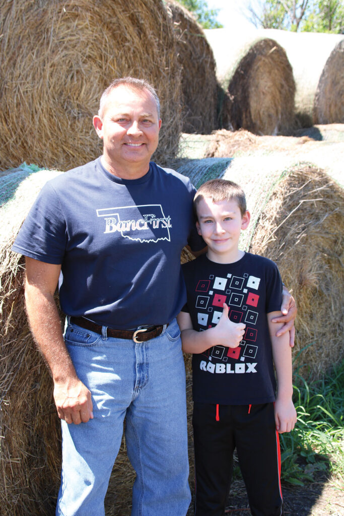 Ray Claggett of Big Cabin, Oklahoma pictured with his son Corban age 11. Photo by Kaylea Hutson-Miller. 
