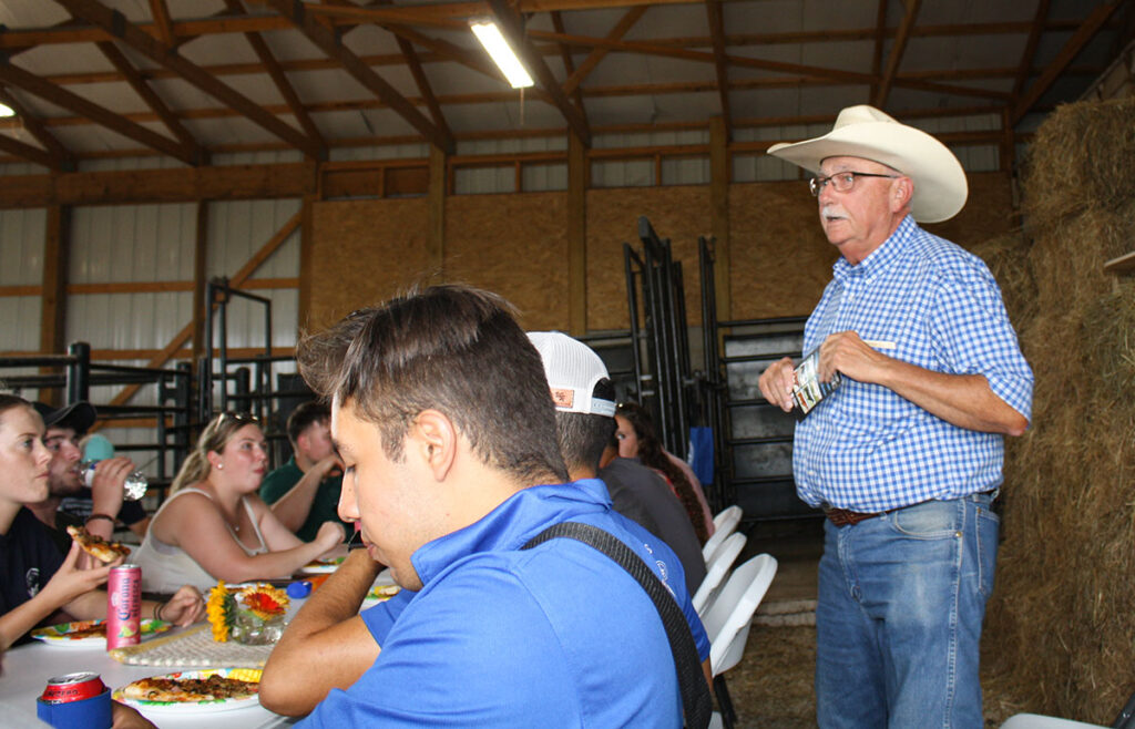 Bruce Bradley speaking to young producers during a meal. Photo by Julie Turner-Crawford. 
