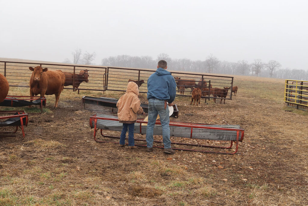 Dan Wisner with his daughter out feeding cattle. Photo by Julie Turner-Crawford. 