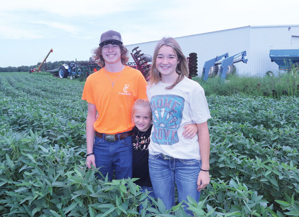 Connor and Ashlyn McCarthy, pictured with their younger sister Sarah, are part of their family’s corn and soybean operation. Photo by Julie Turner-Crawford. 