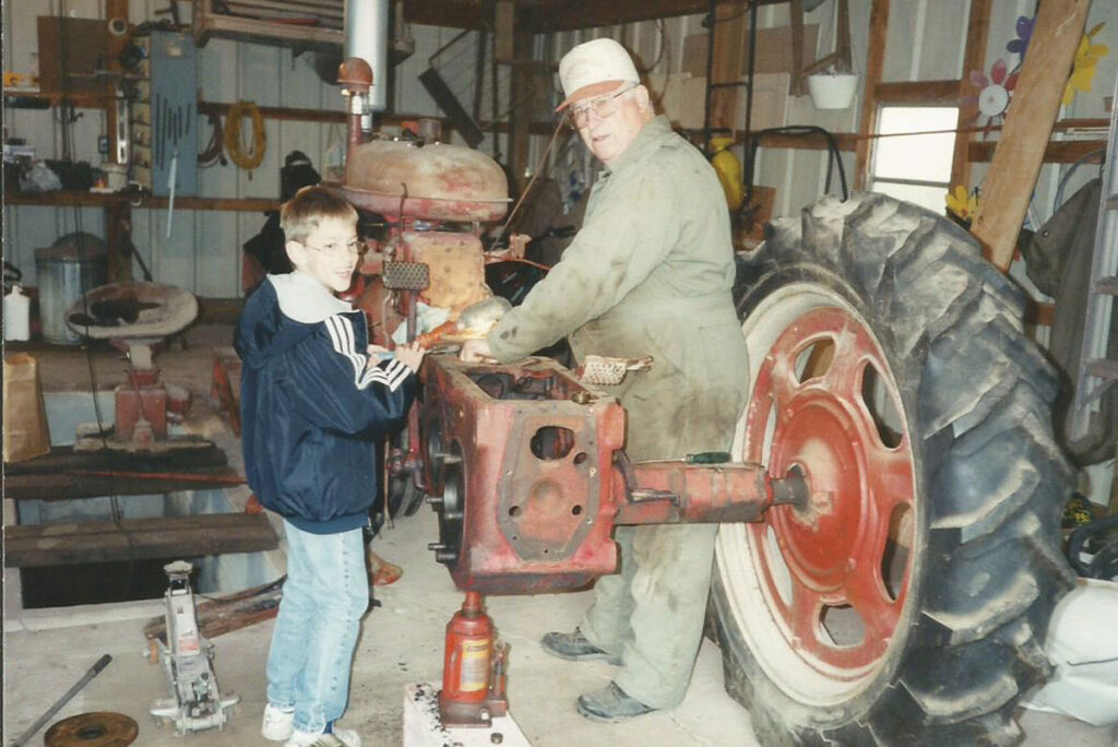 Larry Buckles and his grandson Dirk Jennings work on the restoration of a Super C. Contributed Photo. 